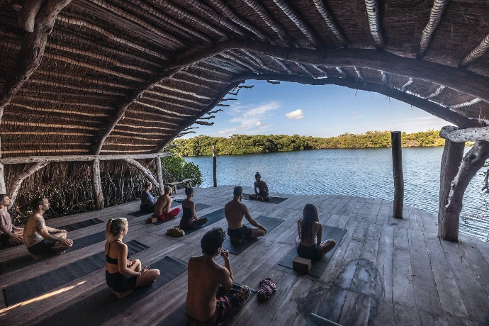 a group of people sitting on top of a wooden floor